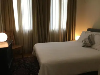 a hotel room with a white bed and windows at Athens-Plaka, Peter's House in Athens