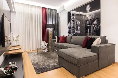 a living room with a couch and a table at Acropolis View Deluxe Penthouse & Luxury Apartments in Athens