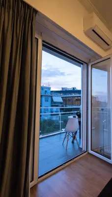 a room with a balcony with a sliding glass door at Acropolis View Deluxe Penthouse & Luxury Apartments in Athens