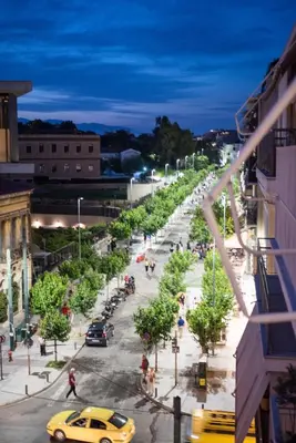 a city street at night with a yellow taxi at Acropolis View Deluxe Penthouse & Luxury Apartments in Athens