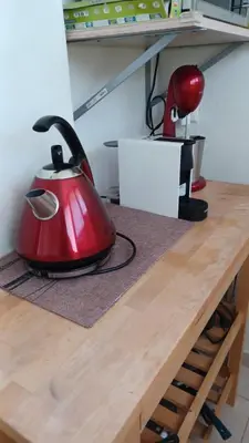 a red tea kettle sitting on top of a wooden table at Central 6th Floor Studio Near Metro & View&200mbps in Athens
