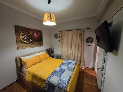 a bedroom with a bed and a flat screen tv at Central 6th Floor Studio Near Metro & View&200mbps in Athens