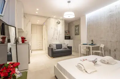a bedroom with a bed and a living room at Stadium HiEnd Studio Top Location in Athens