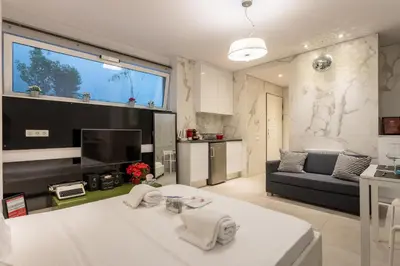 a living room with a couch and a table at Stadium HiEnd Studio Top Location in Athens
