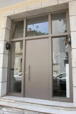 a large white door in a building with windows at Acropolis View Luxury Suite in Athens