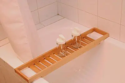 a bath tub with a wooden shelf in a bathroom at Acropolis View Luxury Suite in Athens