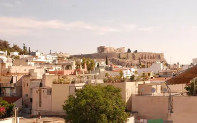 a view of the acropolis from the roofs of buildings at Acropolis View Luxury Suite in Athens