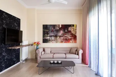 a living room with a couch and a table at Acropolis View Luxury Suite in Athens