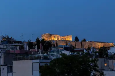 a building on top of a hill at dusk at Acropolis View Luxury Suite in Athens