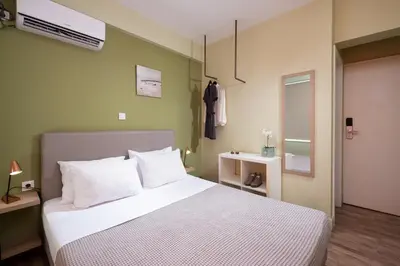 a bedroom with a large bed with white pillows at Enattica Syntagma Living in Athens