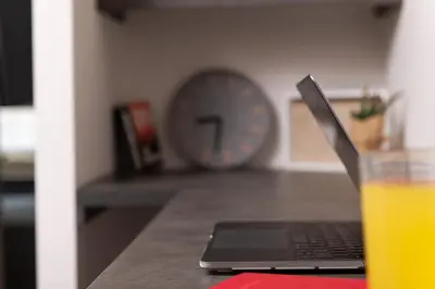 a laptop sitting on a counter with a glass of orange juice at Enattica Syntagma Living in Athens