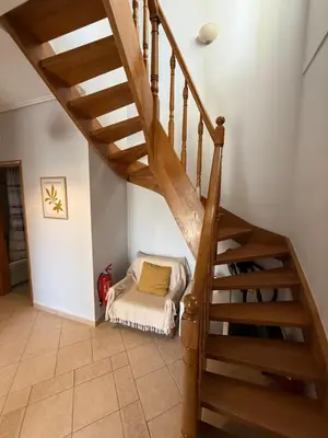 a room with a stairs with a bed in it at Anavyssos Garden House in Palaiá Fókaia