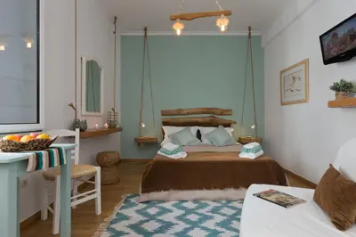a bedroom with a bed and a table and a desk at Athens Wooden Studio in Athens