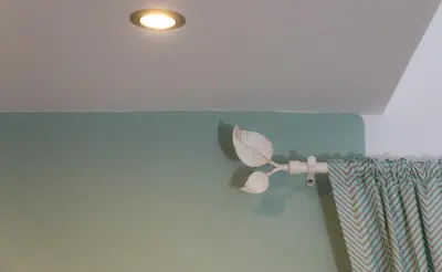 a ceiling light with a butterfly on a curtain at Athens Wooden Studio in Athens
