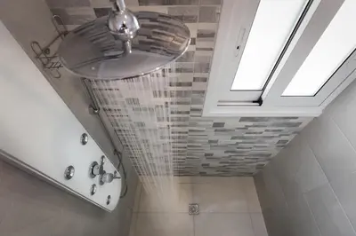 a bathroom with a ceiling fan and a shower at Athens Wooden Studio in Athens