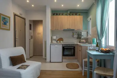 a small kitchen with a couch and a table at Athens Wooden Studio in Athens