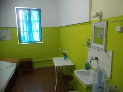 a bathroom with green walls and a sink and a window at Sparti in Piraeus