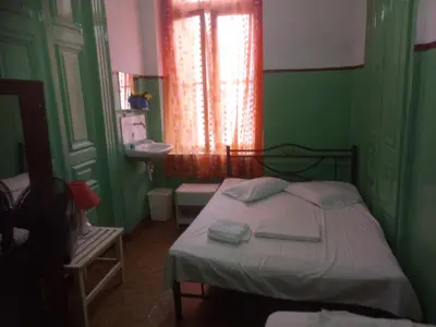 a green bedroom with a bed and a sink at Sparti in Piraeus