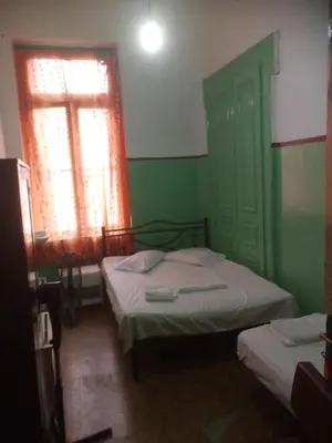 a room with two beds and a window and a window at Sparti in Piraeus
