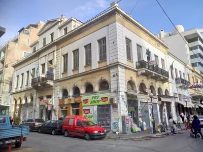 a red van parked in front of a building at Sparti in Piraeus