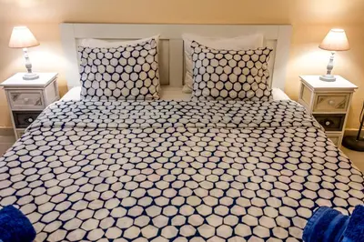 a bedroom with a large bed with two night stands at Zoe's Studio in Athens