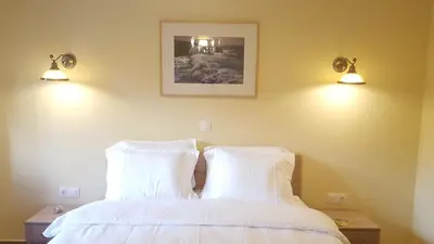 a bedroom with a bed with two white pillows at Zoe's Studio in Athens