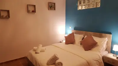 a bedroom with a large white bed with brown pillows at Zoe's Studio in Athens