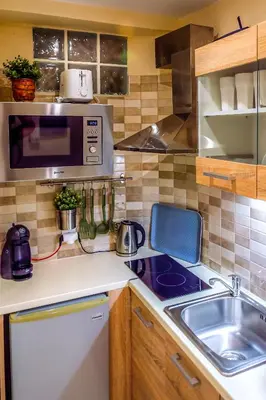 a small kitchen with a sink and a microwave at Zoe's Studio in Athens