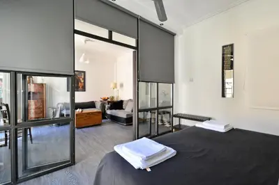 a bedroom with a bed and a living room at Plaka Elegant Apartment in Athens