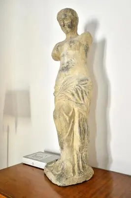 a statue of a woman sitting on top of a laptop at Plaka Elegant Apartment in Athens