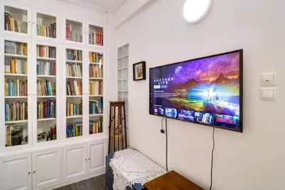 a living room with a flat screen tv on a wall at Plaka Elegant Apartment in Athens
