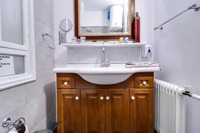 a bathroom with a sink and a mirror at Plaka Elegant Apartment in Athens