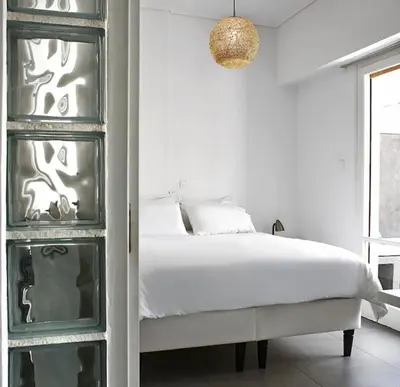 a white bedroom with a bed and a glass cabinet at Acropolis Charming Apartment with Large Balcony - DM17 in Athens