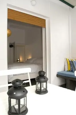 a bedroom with a mirror and two black stools at Acropolis Charming Apartment with Large Balcony - DM17 in Athens