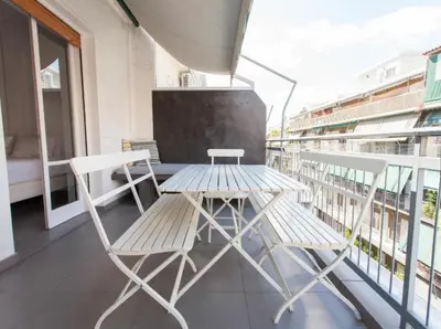 a table and two chairs on a balcony at Acropolis Charming Apartment with Large Balcony - DM17 in Athens