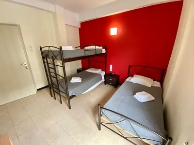 two bunk beds in a room with a red wall at Artemision in Athens