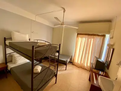 a bedroom with two bunk beds and a window at Artemision in Athens