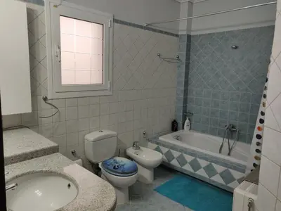 a bathroom with a toilet and a tub and a sink at House,1000m from beach in Lagonissi
