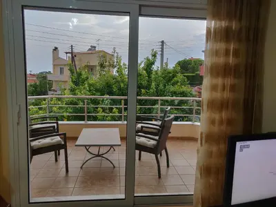 a view of a balcony with a table and chairs at House,1000m from beach in Lagonissi