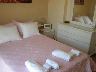 a bedroom with a bed with two towels on it at House,1000m from beach in Lagonissi
