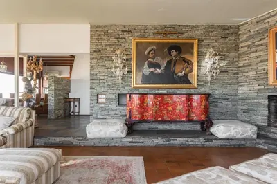 a living room with a fireplace with a painting at Exclusive Spacious Apartment with Expansive City Views - ST8 in Athens