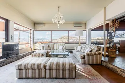 a living room with two couches and a fireplace at Exclusive Spacious Apartment with Expansive City Views - ST8 in Athens