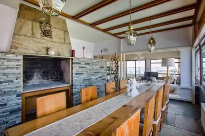 a large dining room with a large stone wall at Exclusive Spacious Apartment with Expansive City Views - ST8 in Athens