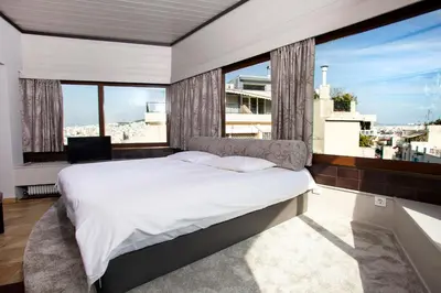 a bedroom with a large bed and large windows at Exclusive Spacious Apartment with Expansive City Views - ST8 in Athens