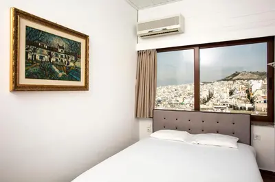 a bedroom with a white bed and a window at Exclusive Spacious Apartment with Expansive City Views - ST8 in Athens