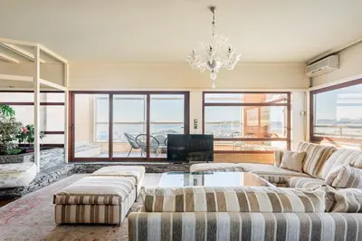 a living room with couches and a chandelier at Exclusive Spacious Apartment with Expansive City Views - ST8 in Athens