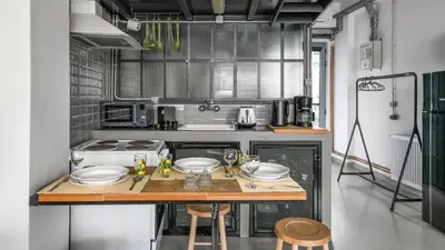 a kitchen with a table with plates on it at Monastiraki Factory CityCenter- Unspoiled Athens Apartments in Athens