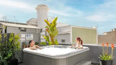 two people in a bath tub on a rooftop at Monastiraki Factory CityCenter- Unspoiled Athens Apartments in Athens