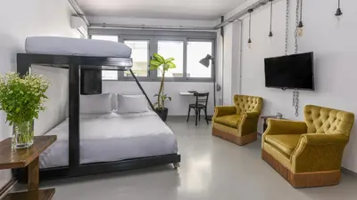 a bedroom with a bunk bed and two chairs at Monastiraki Factory CityCenter- Unspoiled Athens Apartments in Athens