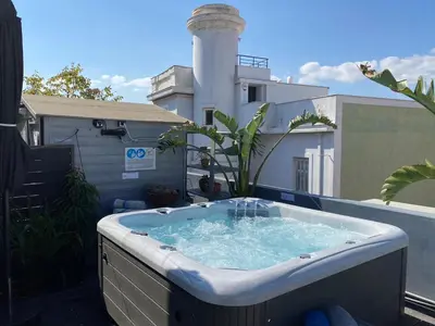 a hot tub sitting on top of a balcony at Monastiraki Factory CityCenter- Unspoiled Athens Apartments in Athens